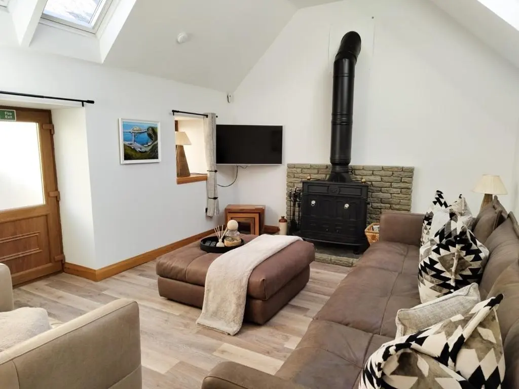 a living room with a bed and a fireplace at Portknockie 17 Harbour Place in Portknockie
