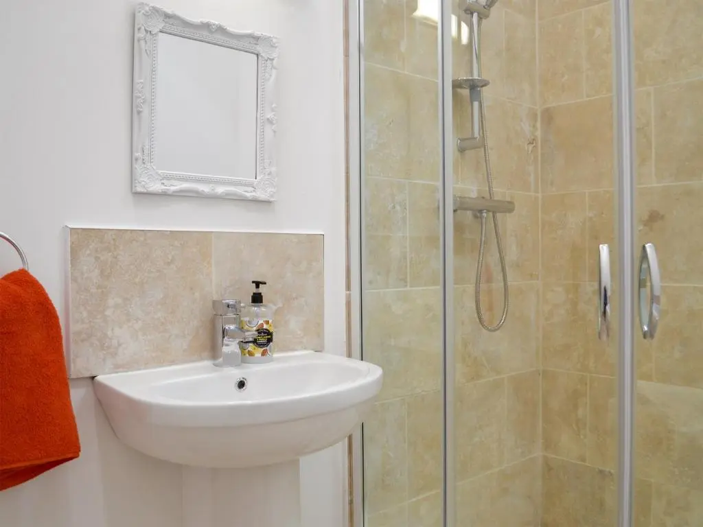 a bathroom with a sink and a shower at Wester Laggan Cottage in Skye of Curr
