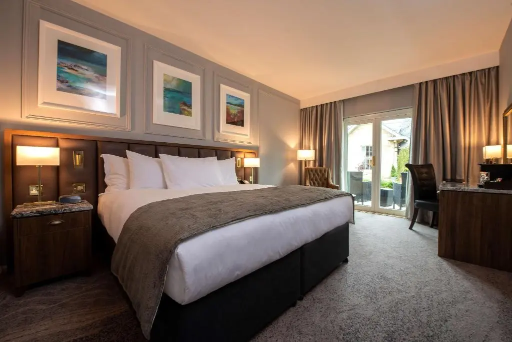 a hotel room with a large bed and a window at Ness Walk in Inverness