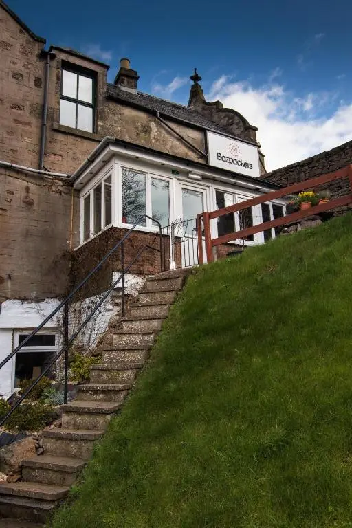 an old house with stairs leading up to it at Bazpackers in Inverness