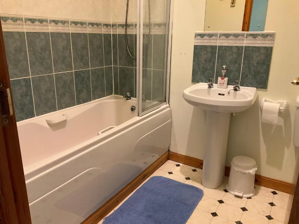 a bathroom with a sink and a tub and a toilet and a sink at Courtyard Cottage Free Parking in Inverness