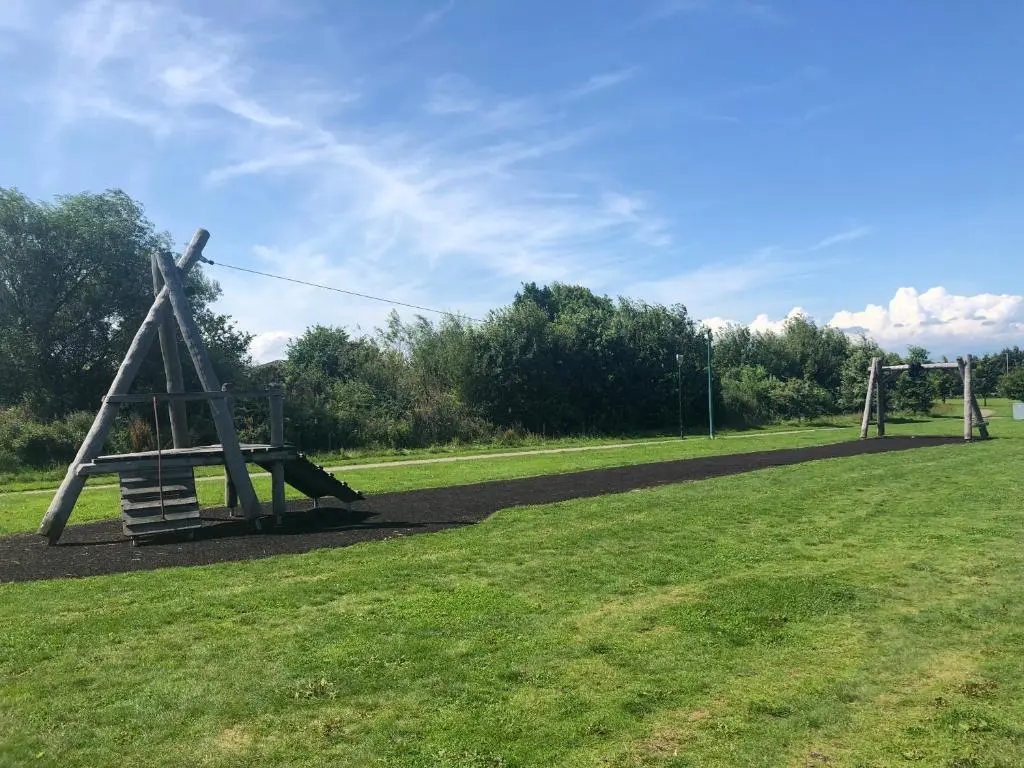an empty playground in a grassy field at Two Bedroom Glen View Free Parking in Inverness
