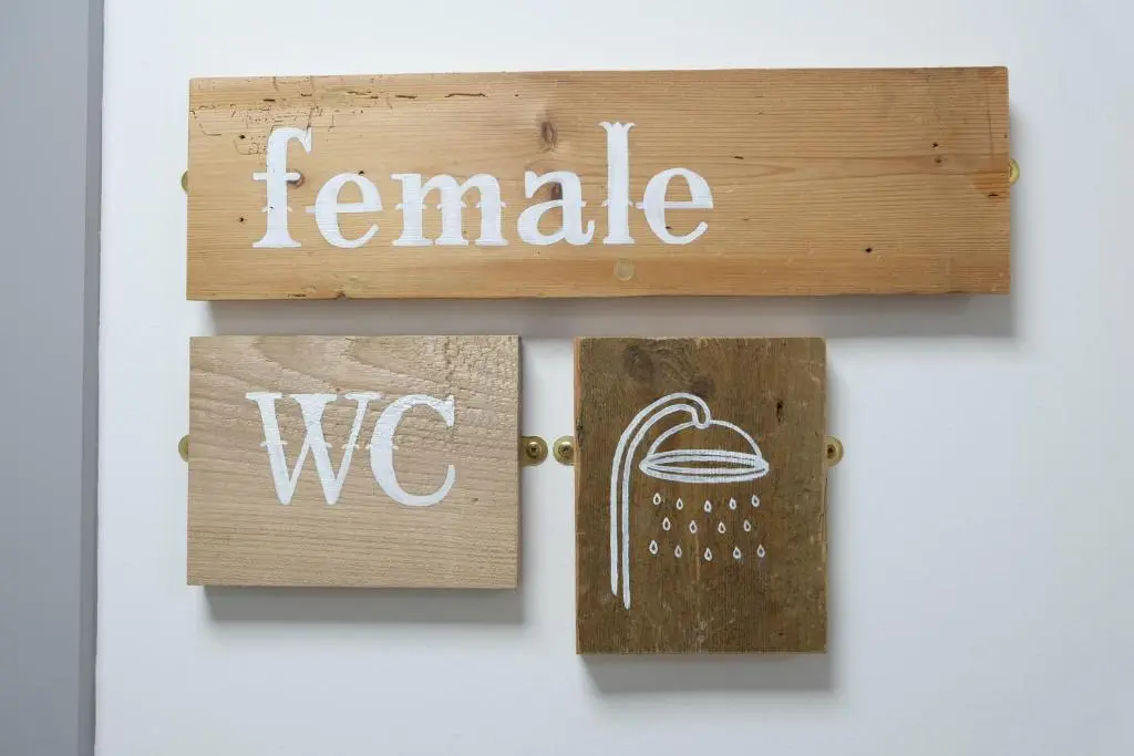 a sign that says female and wc on a door at Black Isle Hostel in Inverness