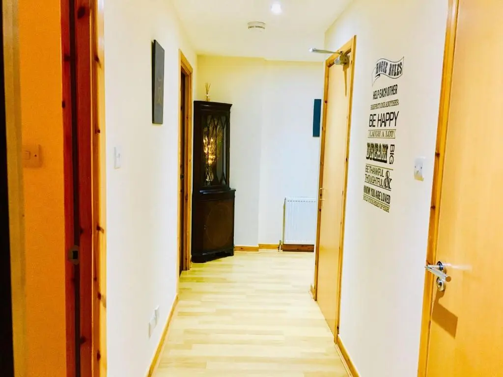 an empty hallway with a hallway at Azim and Suzi\u2019s city centre apartment Inverness in Inverness