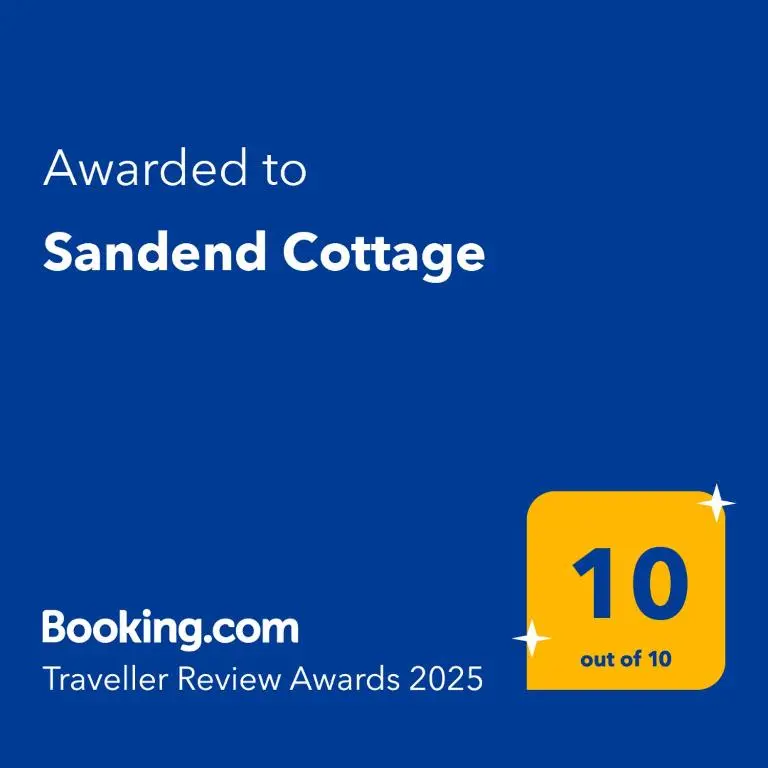 a yellow square with the words awarded to sandard college at Sandend Cottage in Banff