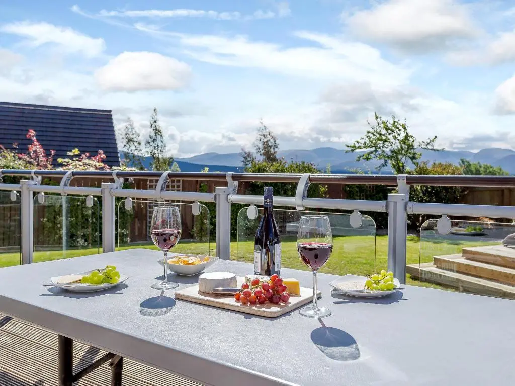 a table with wine glasses and a tray of fruit at The Lookout in Aviemore