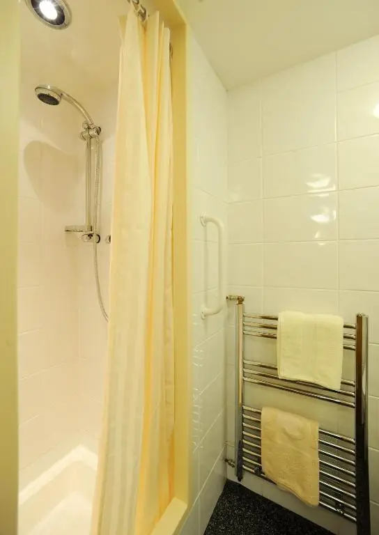a bathroom with a shower with a shower curtain at The Boat and Breakfast in Inverness