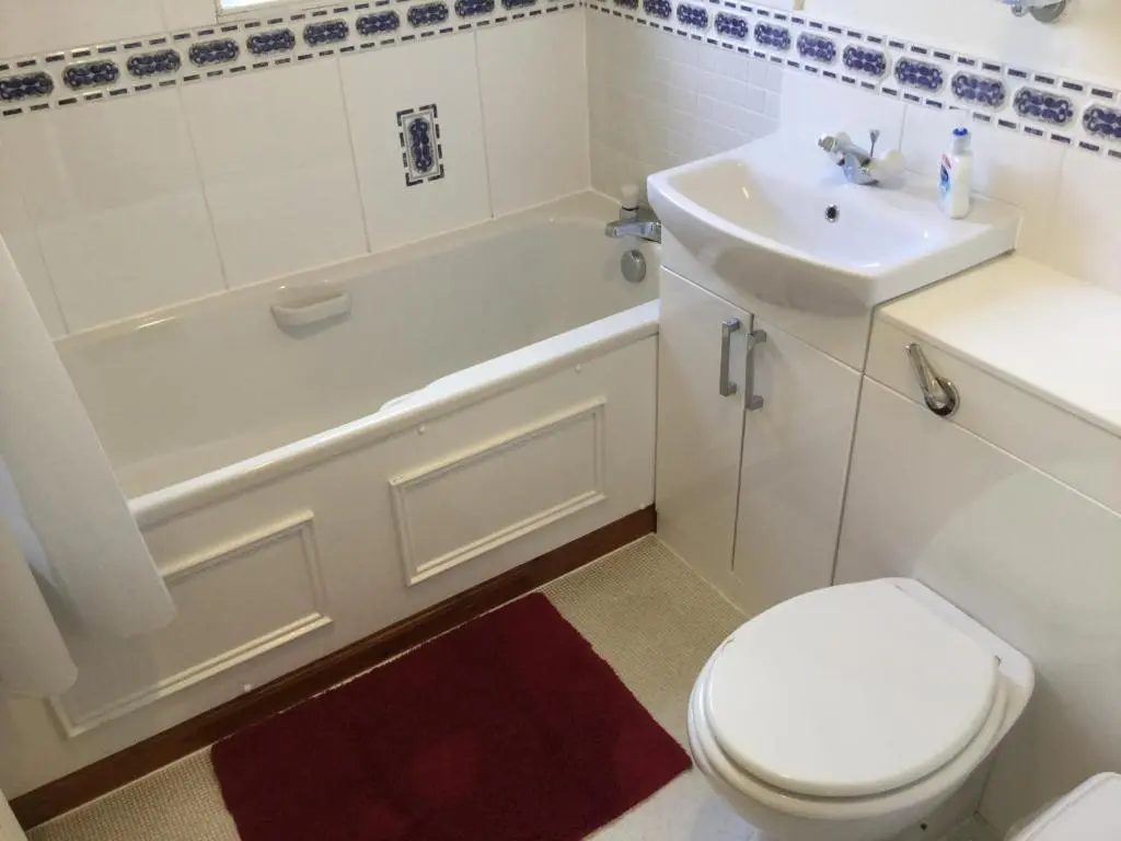 a bathroom with a white toilet and a sink at Two-Bedroom Apartment - Golf View Free Parking in Inverness