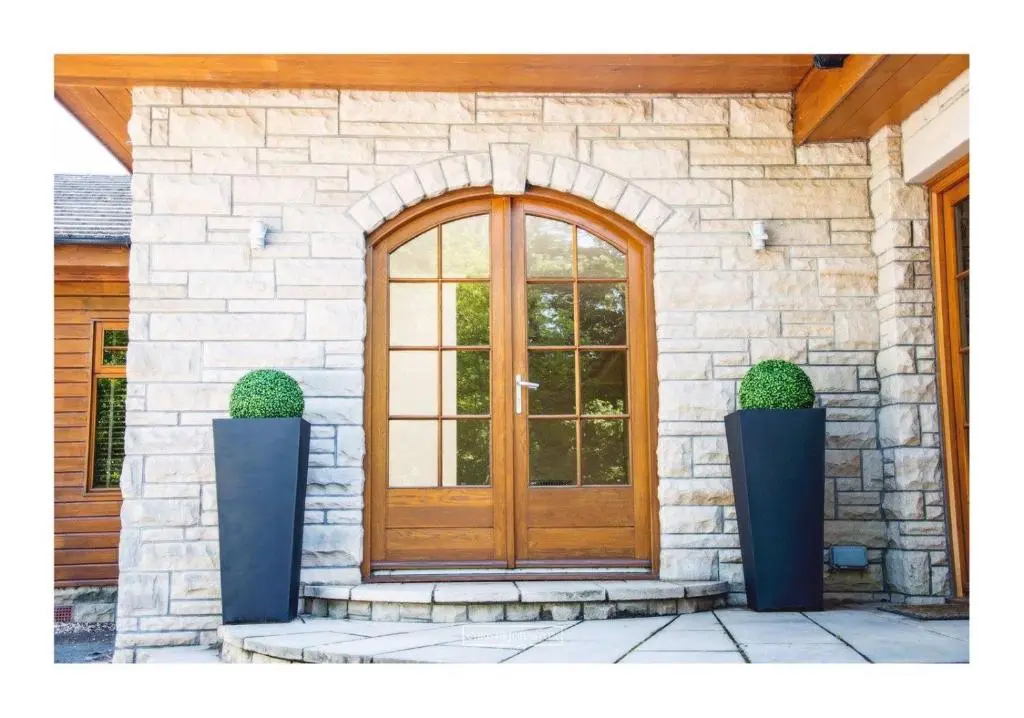 a front door of a house with two potted plants at Craig Alvah Lodge in Banff