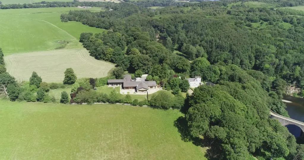 an aerial view of a house in the middle of a field at Craig Alvah Lodge in Banff