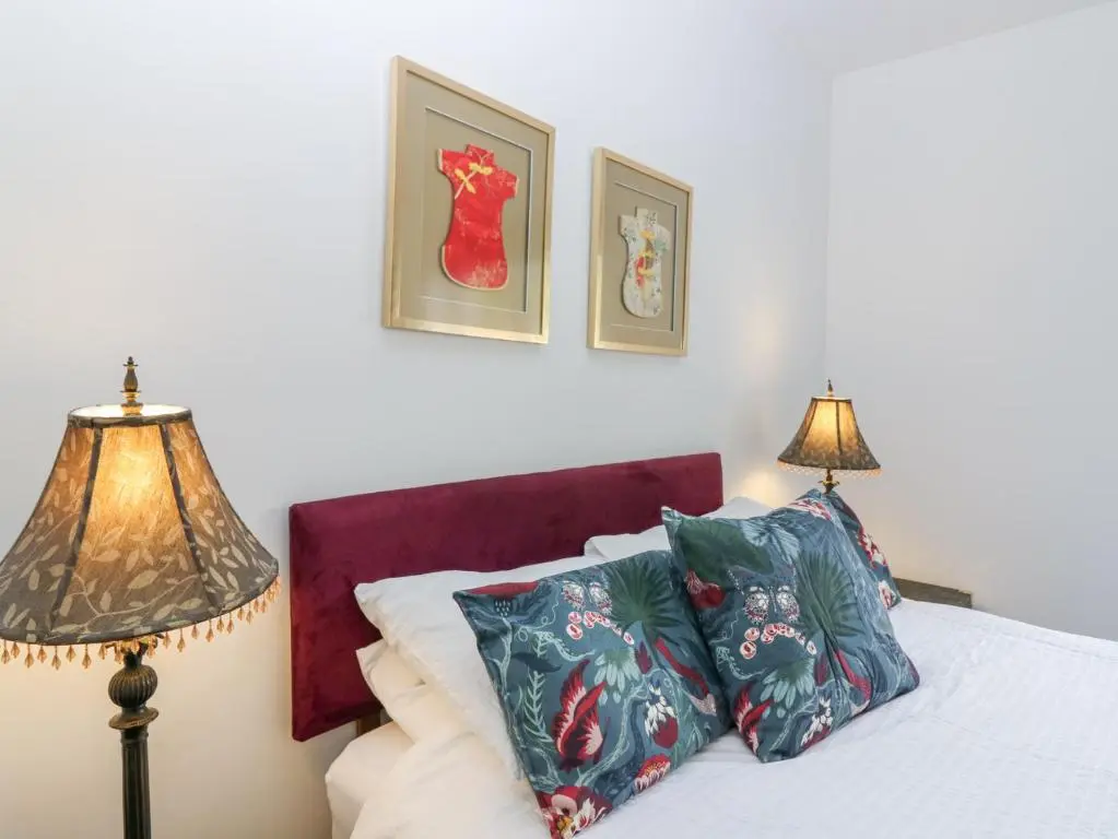 a bedroom with a bed with two lamps on it at P'lace of Glassaugh in Banff