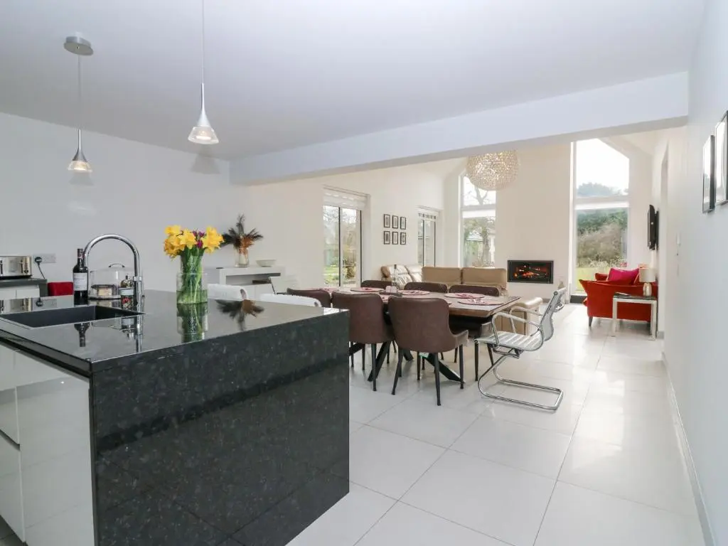 a kitchen and living room with a table and chairs at P'lace of Glassaugh in Banff