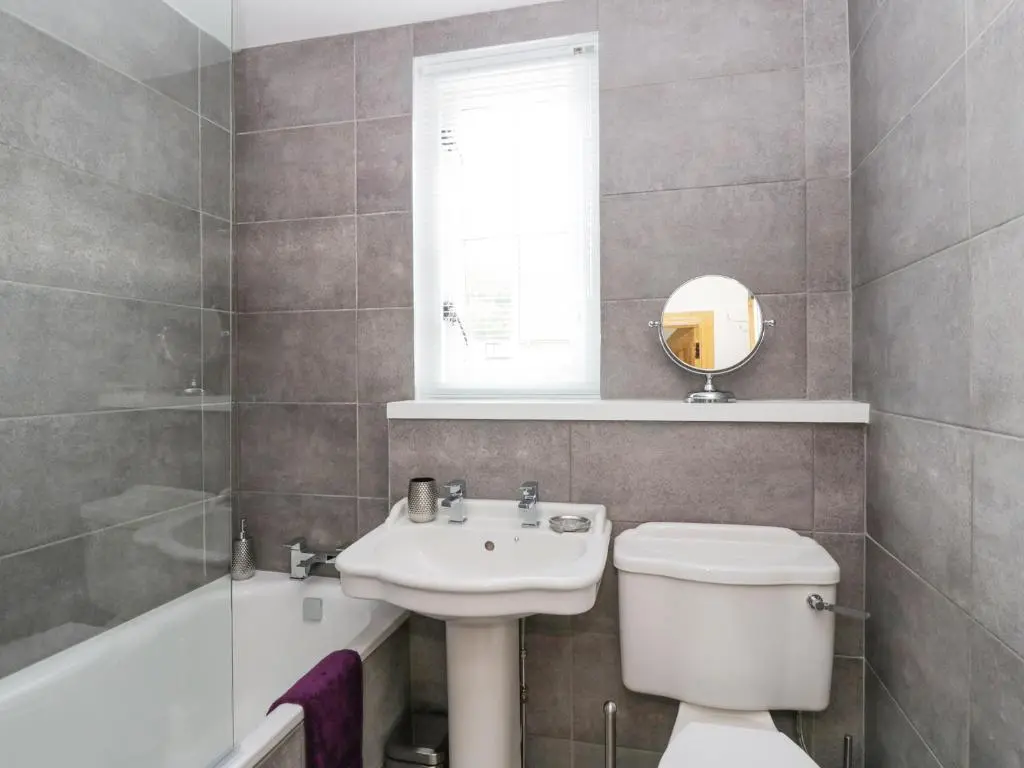 a bathroom with a sink and a toilet and a tub at Westwood in Ballater