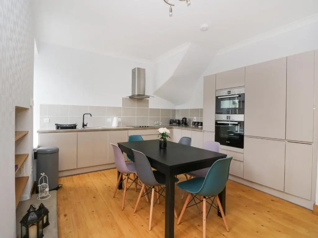 a kitchen with a black table and chairs at Westwood in Ballater