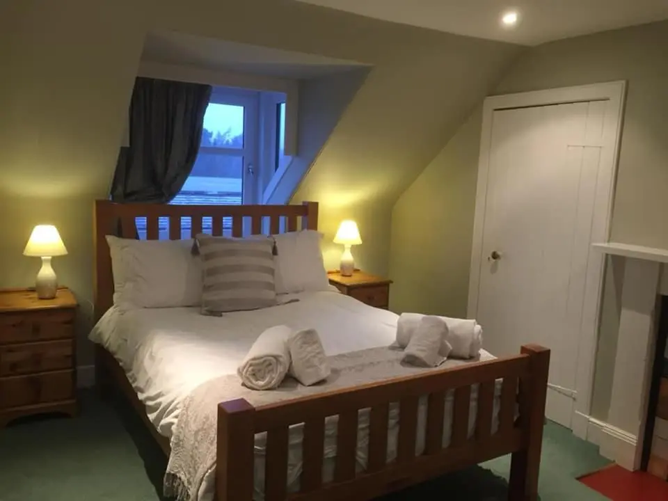 a bedroom with a bed with towels on it at The Cottage Aberlour in Aberlour
