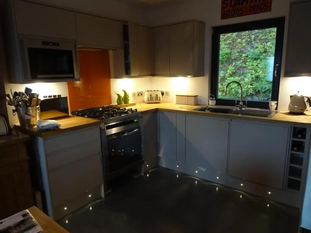 a kitchen with a stove and a sink and a window at The Loft at Log Ness in Foyers
