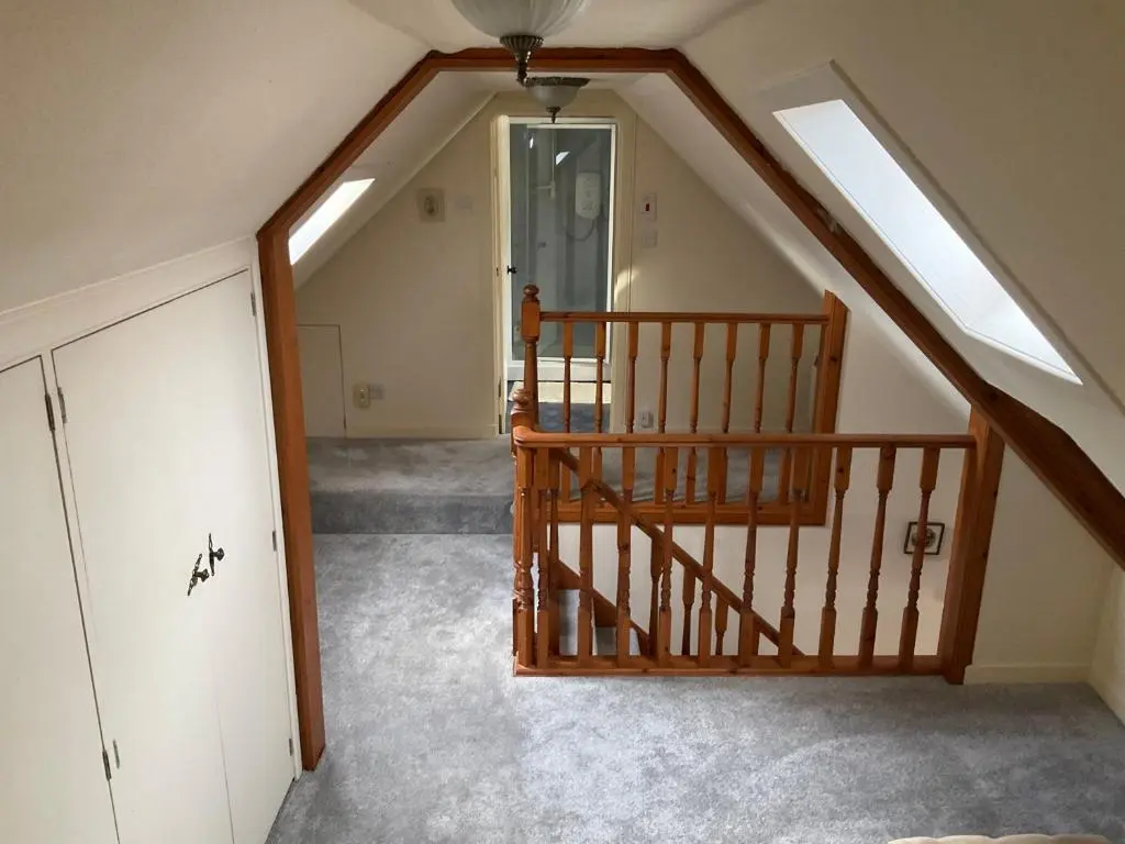 an attic room with a staircase and a door at Three-Bedroom Old Cottage Free Parking in Inverness