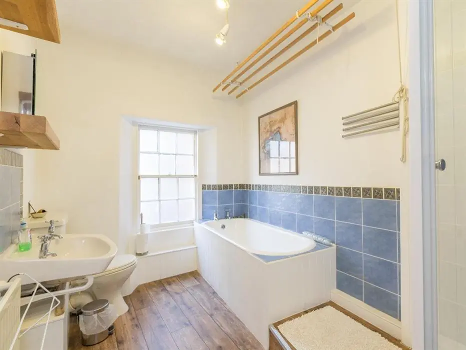 a bathroom with a tub and a sink at River Cottage in Inverness