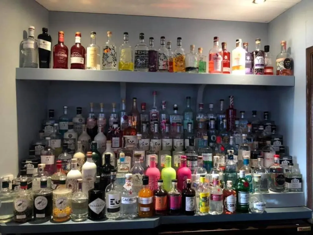 a shelf filled with lots of bottles of alcohol at GOLF View Hotel & Macintosh Restaurant in Lossiemouth