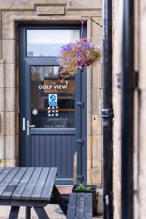 a blue door with a potted plant in front of it at GOLF View Hotel & Macintosh Restaurant in Lossiemouth