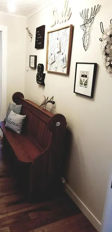 a room with a bench on a wall with pictures at Airanloch Bed & Breakfast,Loch Ness, Adult Only in Lochend