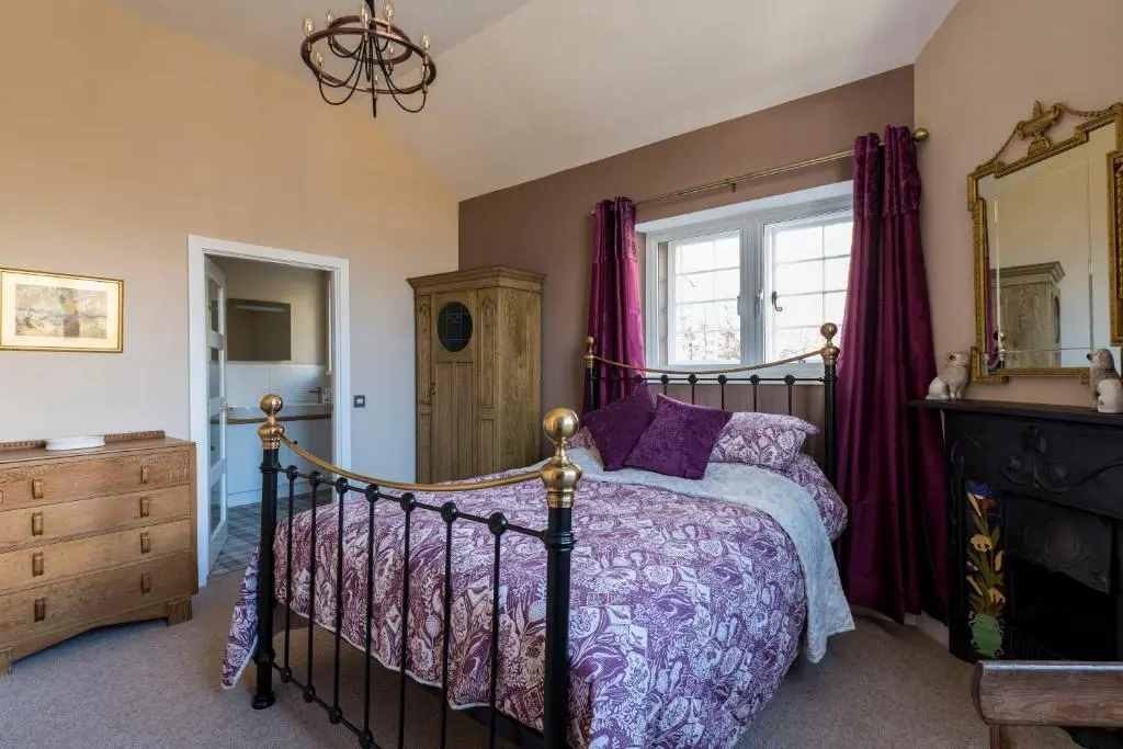 a bedroom with a bed and a window at Evelix, The Old School House in Muir of Ord