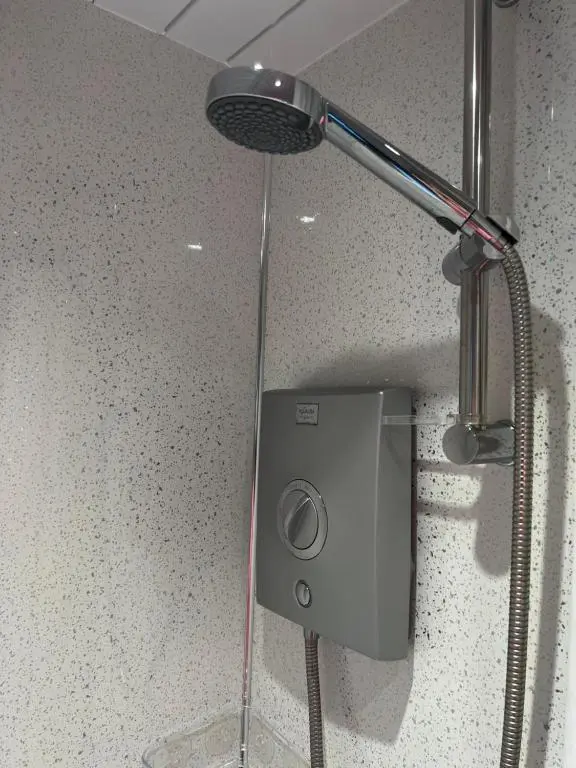 a shower with a shower head on a counter at The Sheriffs Lodge in Dingwall