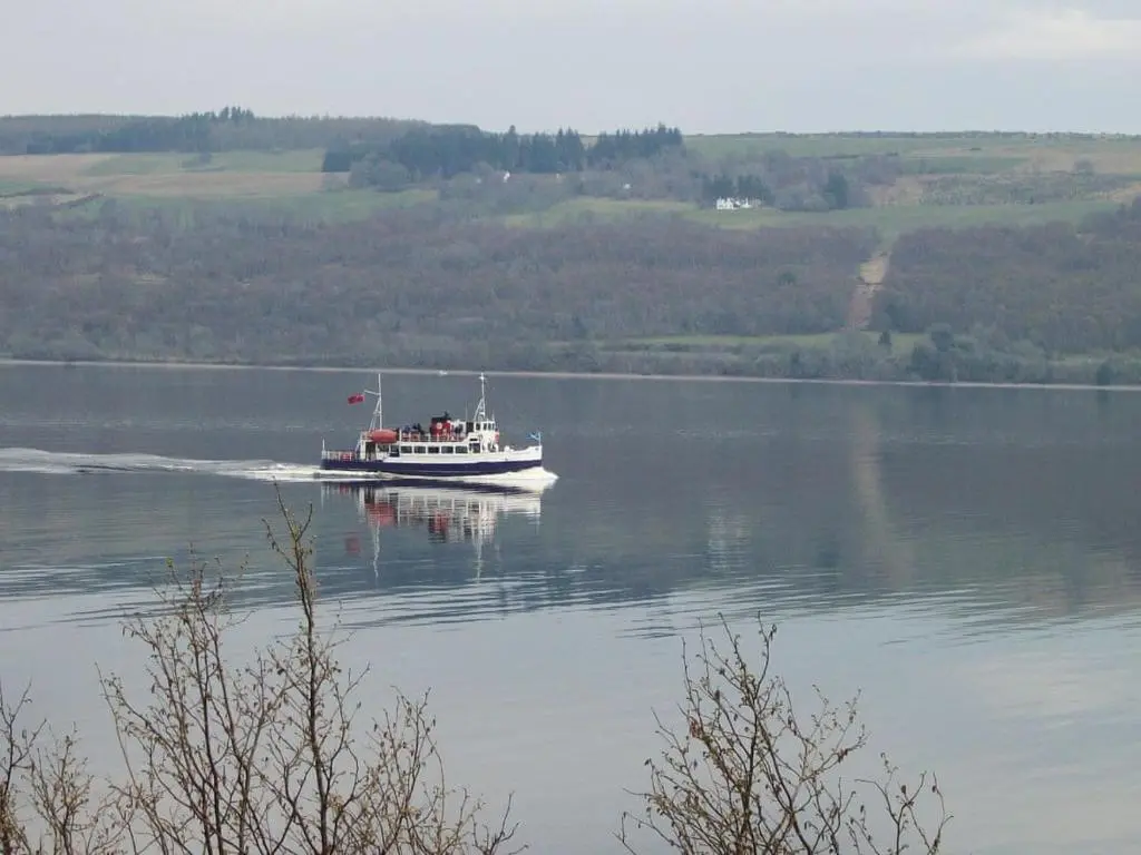 a boat on a large body of water at Loch Ness Studio Blairbeg in Drumnadrochit