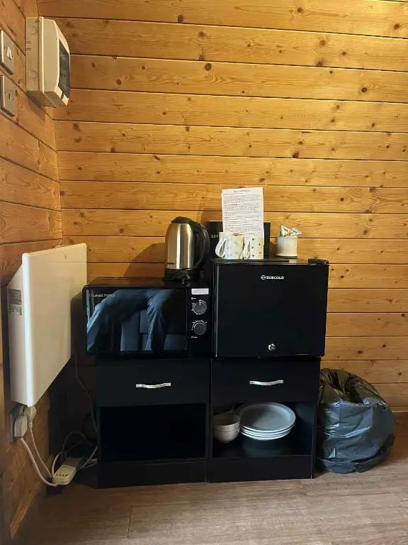 a kitchen with a microwave and a stove at Pine Marten Bar Glenmore Pods in Aviemore