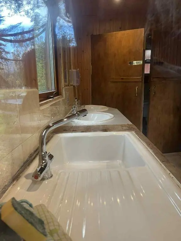 a bathroom with a tub and a sink at Pine Marten Bar Glenmore Pods in Aviemore