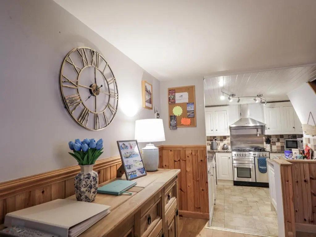 a kitchen with a large clock on the wall at 83 Seatown in Buckie