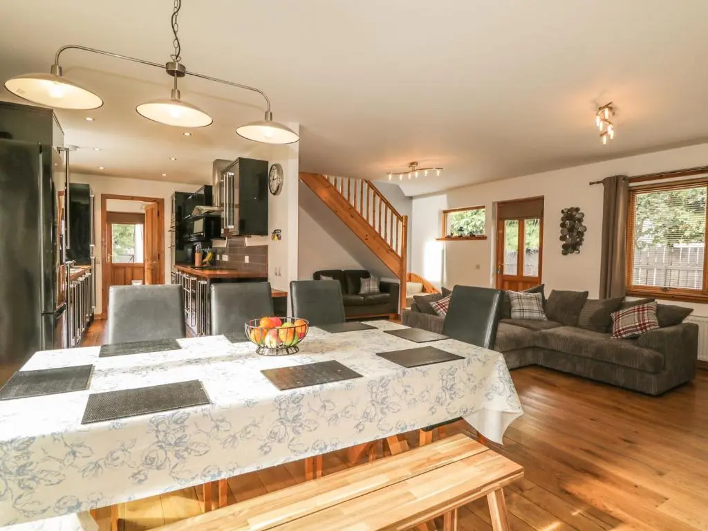 a kitchen and living room with a table and chairs at Dolce Casa in Grantown on Spey