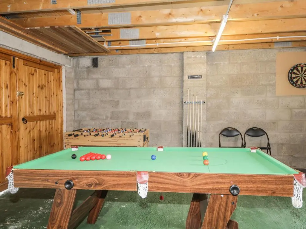 a ping pong table in a room with at Dolce Casa in Grantown on Spey