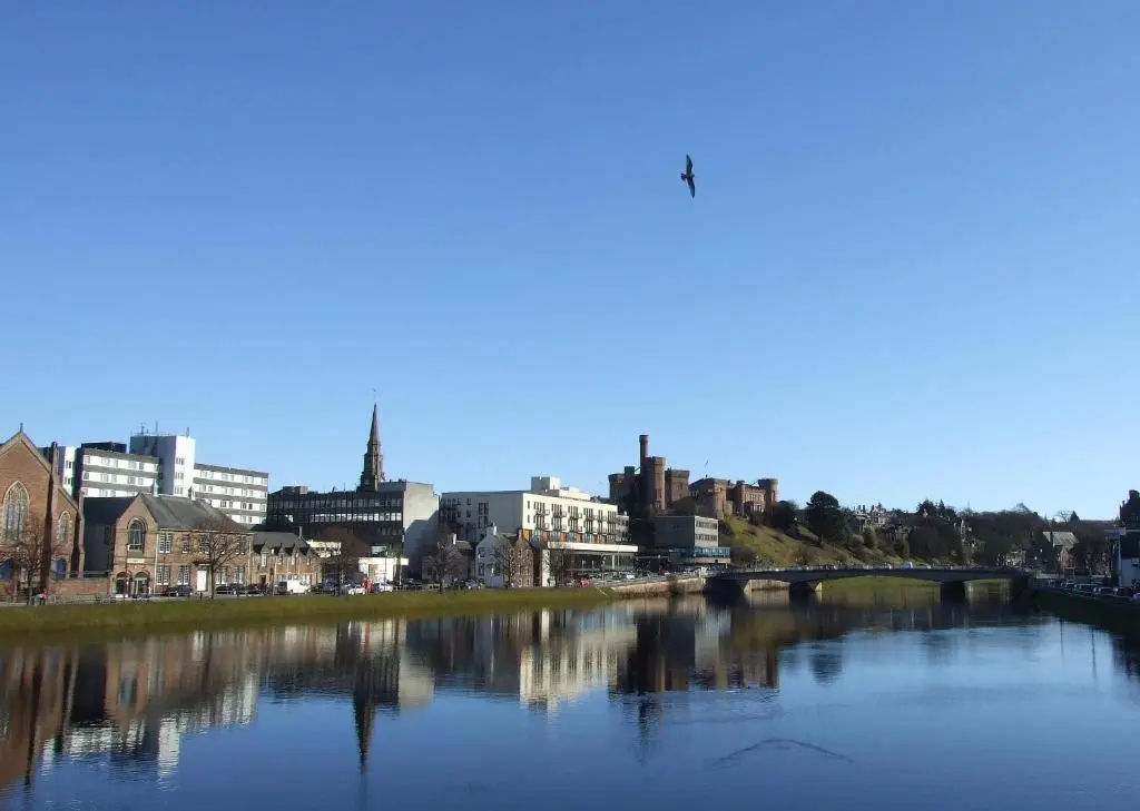 a view of a city with a river and a bridge at Innes Street Apartments in Inverness