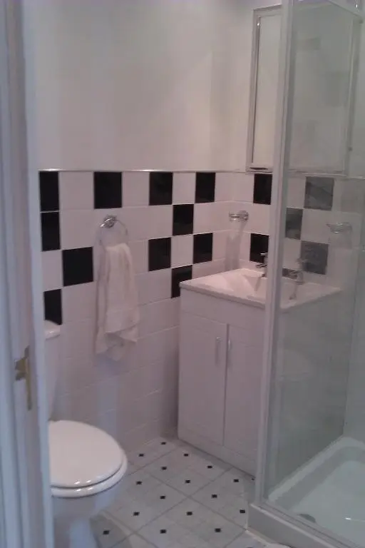a bathroom with a toilet and a sink and a shower at Harbour House Bed & Breakfast - Wick in Wick