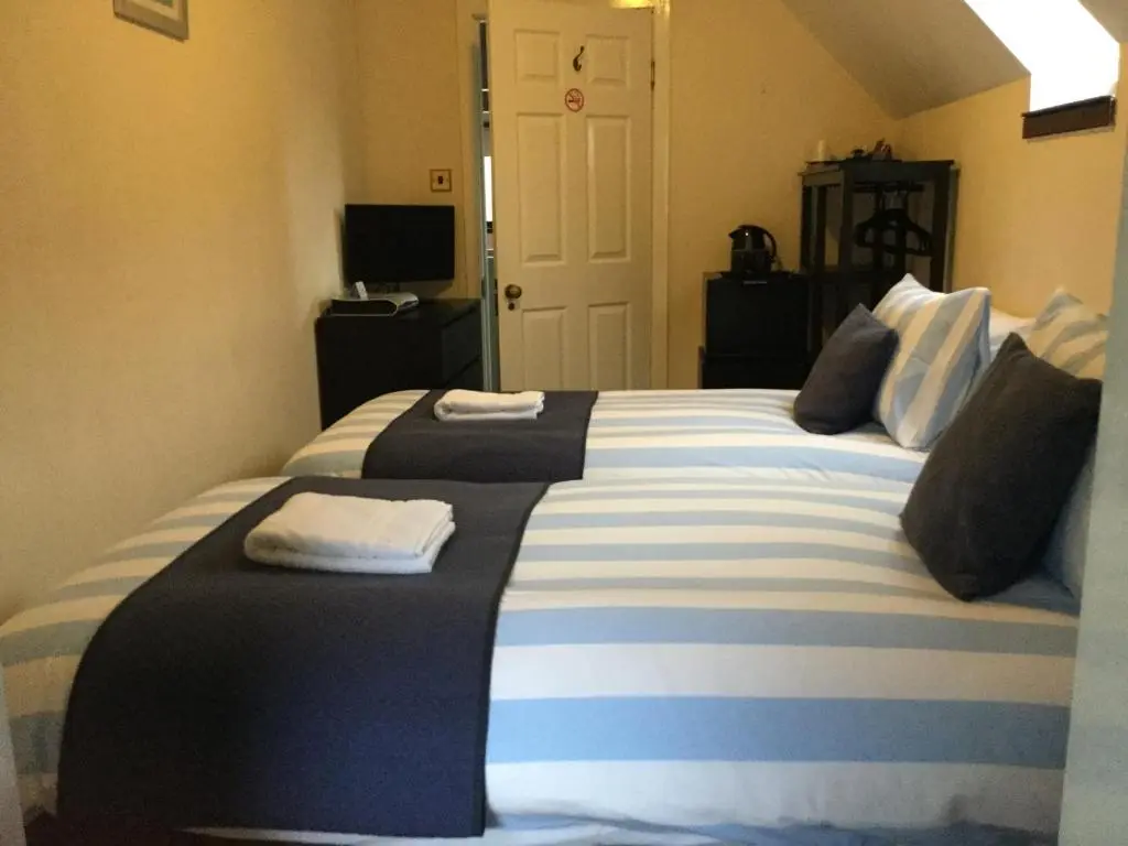 a bedroom with a large bed with towels on it at Darroch View B&B in Invermoriston