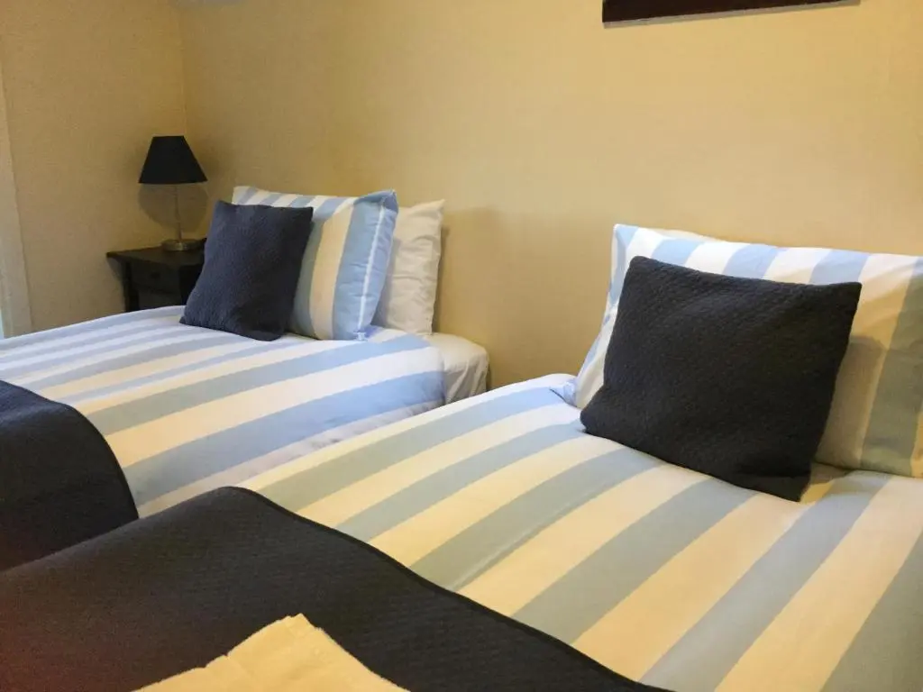 two beds sitting next to each other in a room at Darroch View B&B in Invermoriston