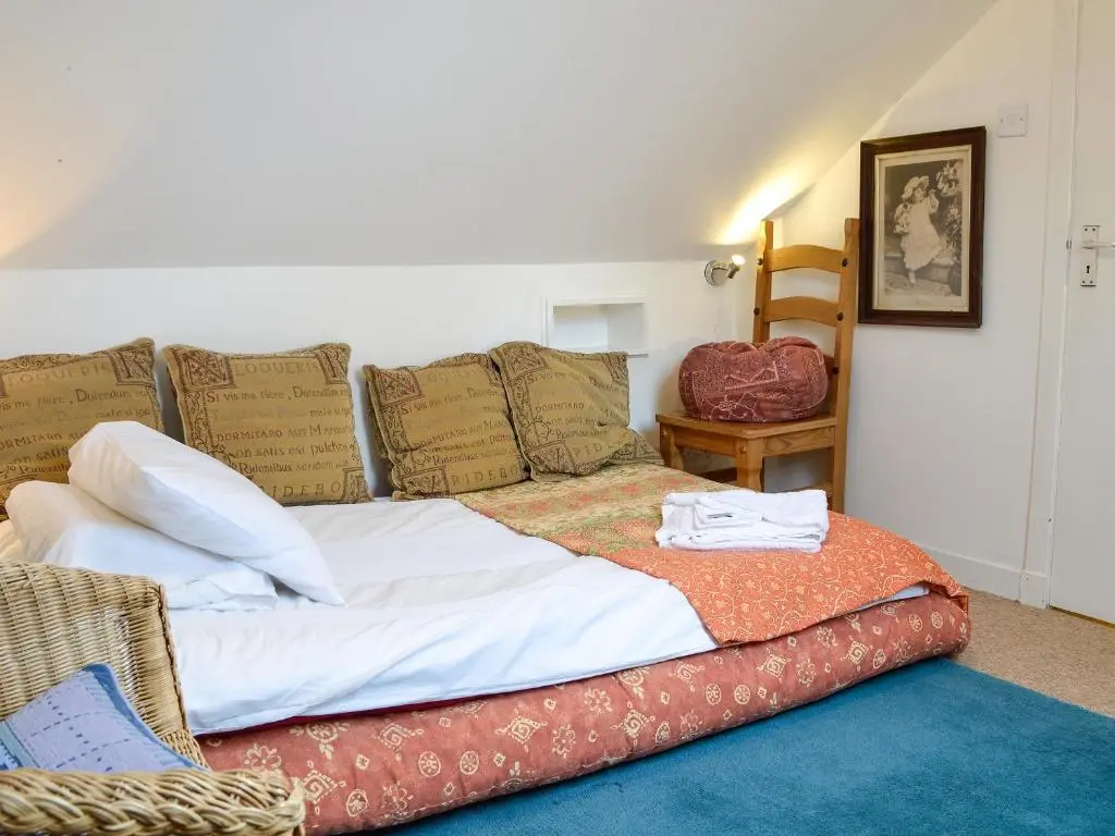 a large bed with pillows on it in a room at Ruach in Gardenstown