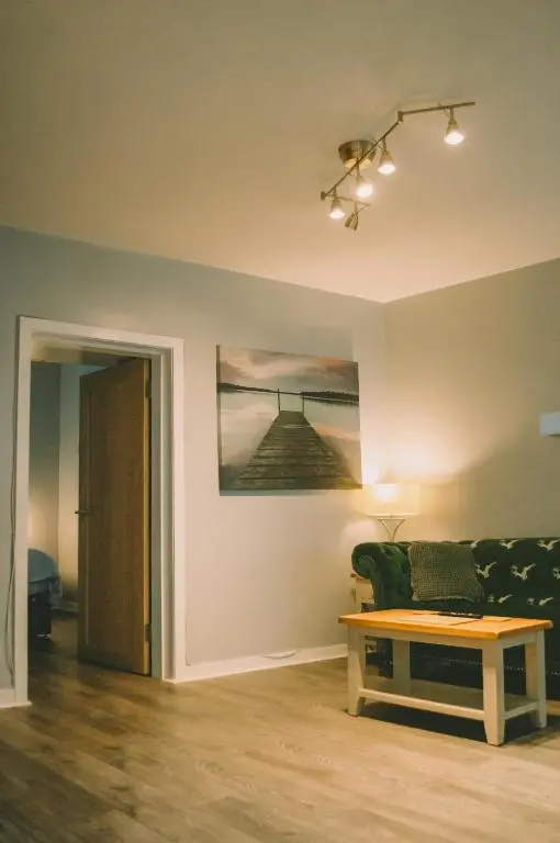 a living room with a couch and a table at The Black Isle Retreat in Inverness