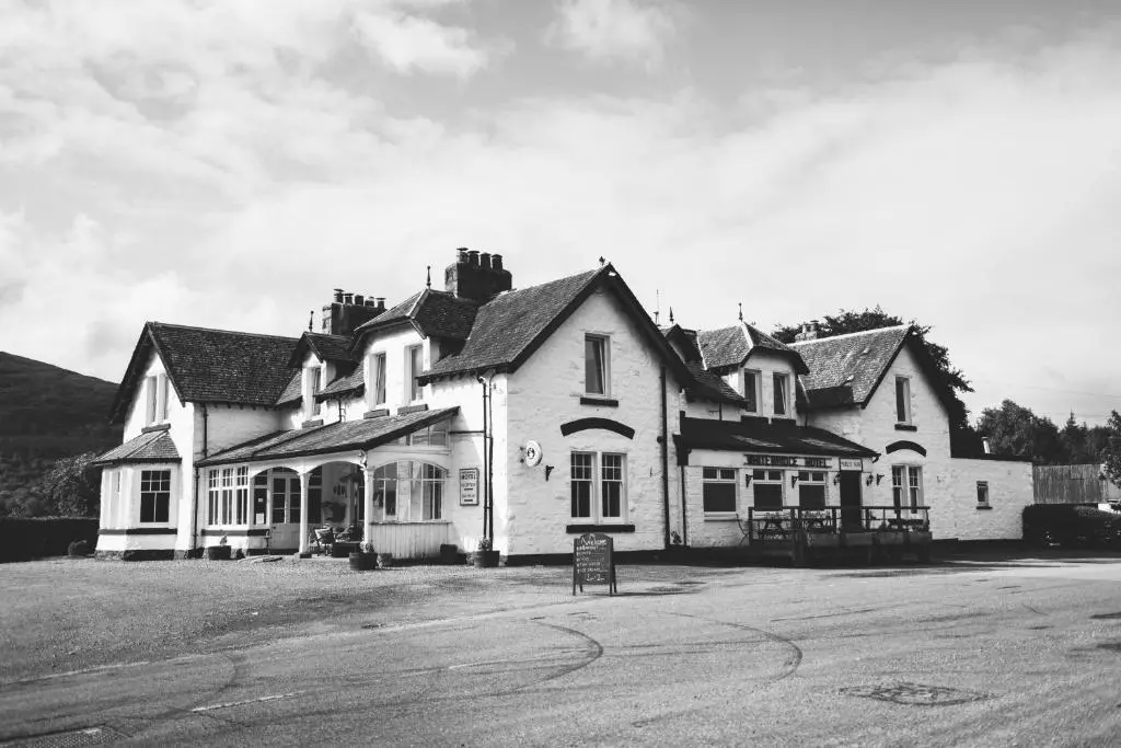 a black and white photo of a large house at Whitebridge Hotel in Whitebridge