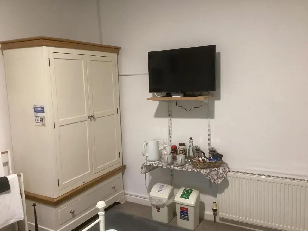 a corner of a room with a tv on the wall at Alba b & b in Inverness