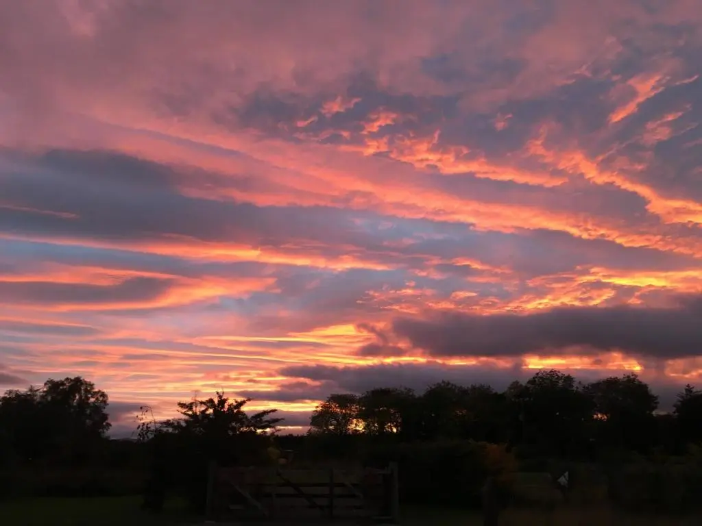 a sunset in the sky with clouds at Evelix Pods Dornoch in Dornoch