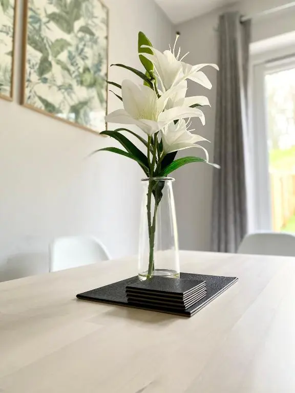 a vase of white flowers sitting on a table at Lily Bank House in Inverness