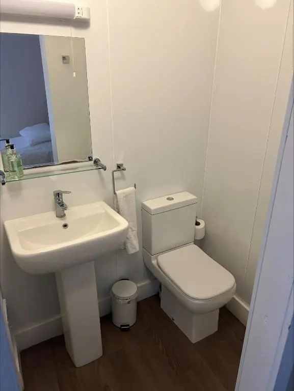 a bathroom with a white toilet and a sink at Whisky Capital Inn in Dufftown