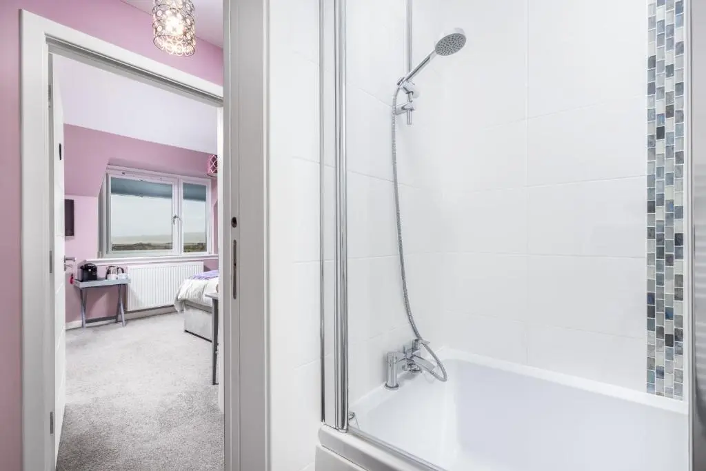 a bathroom with a shower with a glass door at Heartseed House Bed & Breakfast in Dornoch