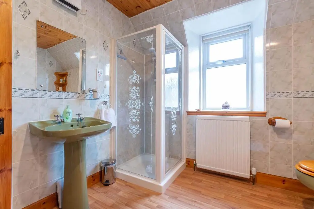 a bathroom with a shower and a sink at Convalmore House in Dufftown