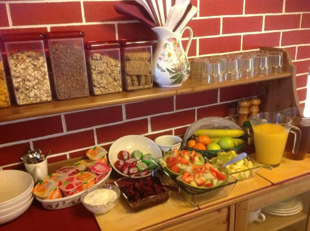 a counter with many bowls of food on it at Dunroamin Bed and Breakfast in Aviemore