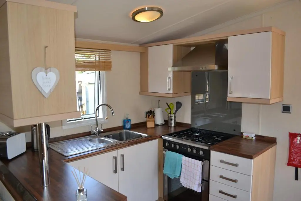 a kitchen with a sink and a stove at Braemar in Dornoch