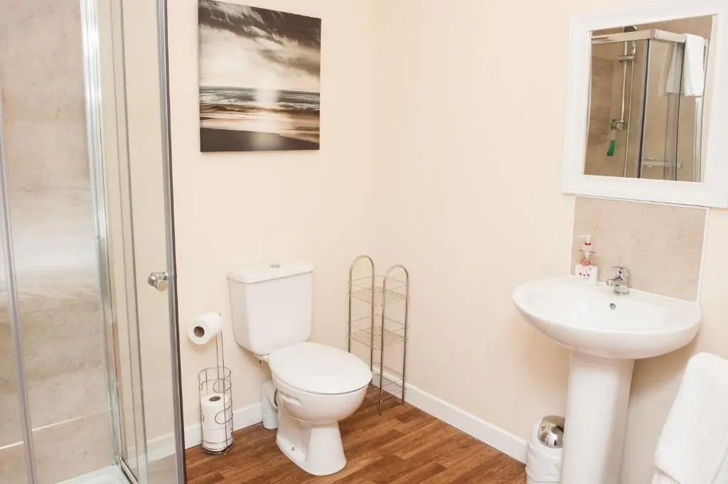 a bathroom with a toilet and a sink at Ardross Glencairn in Inverness