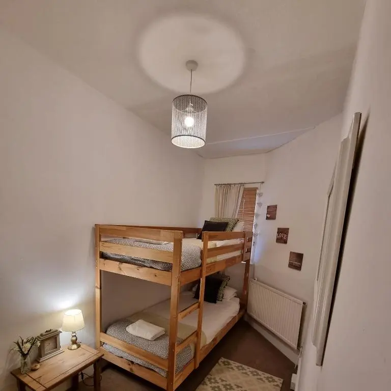 a room with two bunk beds and a light at Inverness City Centre Flat in Inverness